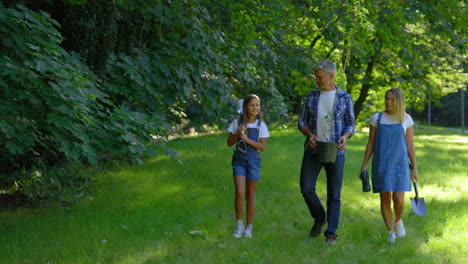 family planting a tree in the park
