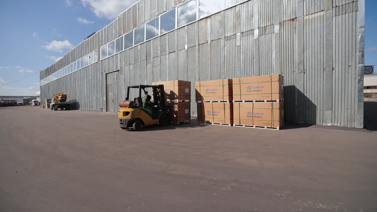 Forklift loading solar panels in a warehouse