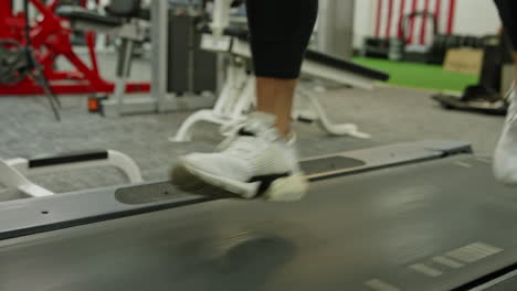 male jogger exercising on treadmills, doing fitness exercise