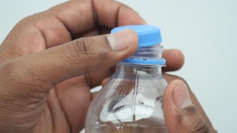 open a cap of a plastic water bottle