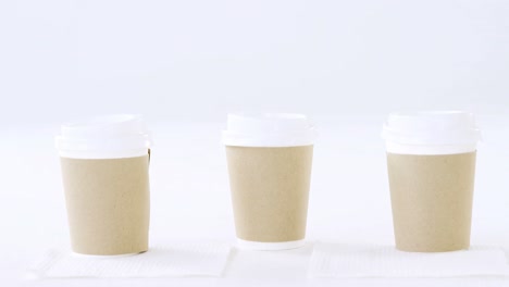 disposable coffee cups on white background