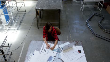 female welder working at desk 4k