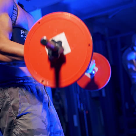 young brutal sexy strong bodybuilder athletic fitness man pumping up barbell. abs muscles workout bodybuilding concept background. blue light filter.