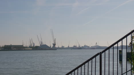 towering cranes over a port in the distance