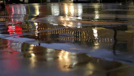 rain drops on wet asphalt of city street in usa, raindrops falling, reflections.