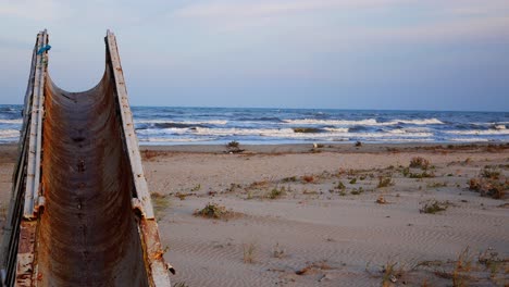 Close-up-shot-of-an-abandoned-metallic-structure-in-the-beach