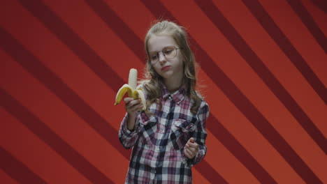 girl peeling and eating a banana