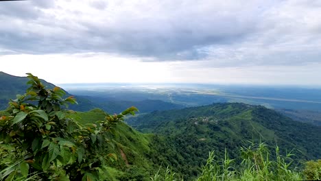 mountain range covered with forests and dramatic cloudy sky at morning