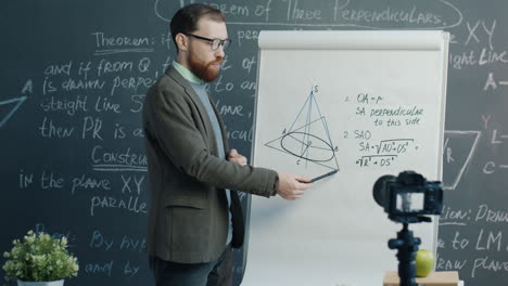 math teacher presenting geometry lesson on whiteboard