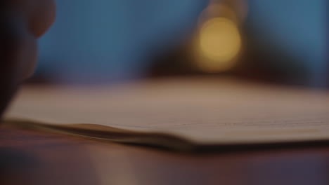 person writing in a notebook at night