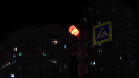 green pedestrian light at night in city