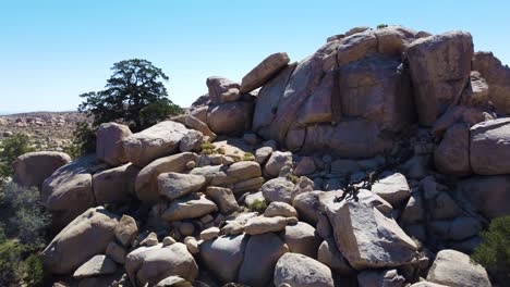 fly over huge pile of boulders and reveal deserted terrain in horizon