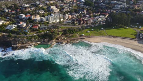 scenery of ocean waves crashing at bronte baths and sandy shoreline at sydney, australia