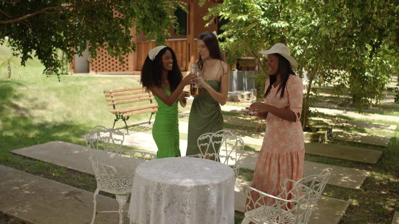 Friends Enjoying Drinks and Conversation in a Sunny Garden