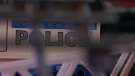 police letters viewed on police car through fence