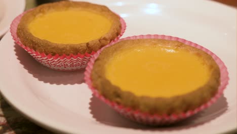 hong kong egg tarts feature a flaky pastry crust filled with smooth, creamy egg custard