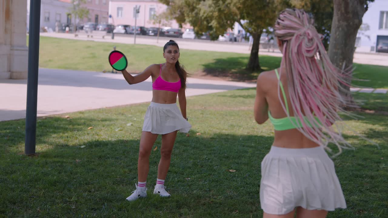 Women playing paddle ball in the park
