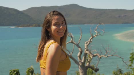 Portrait-Of-A-Happy-Tourist-Against-Rugged-Hook-Island-Background,-Langford-In-Whitsundays-Island,-QLD-Australia