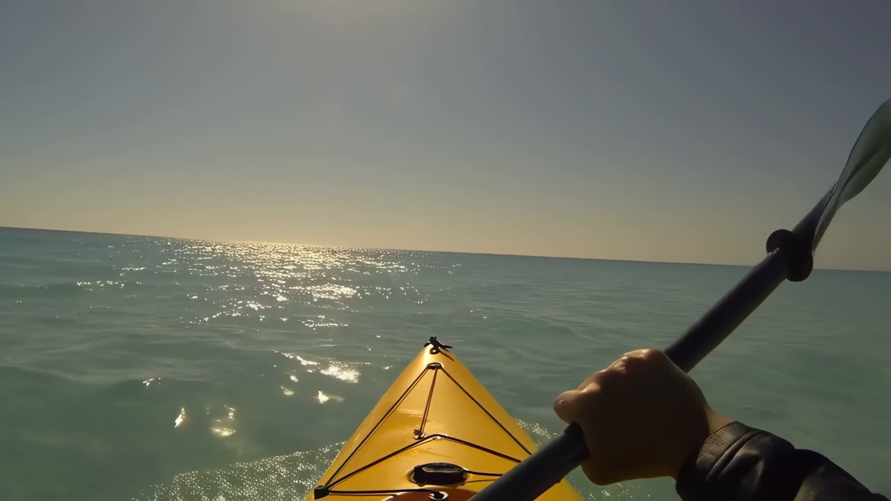 First-person view of kayaking on clear blue water