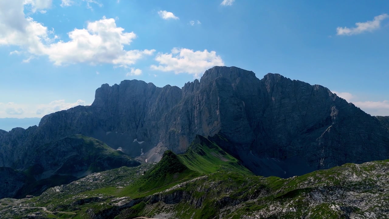 Flygfoto med drönare över de massiva kalkstenstopparna och den robusta alpina terrängen i Presolanamassivet i Val di Scalve, Italien.