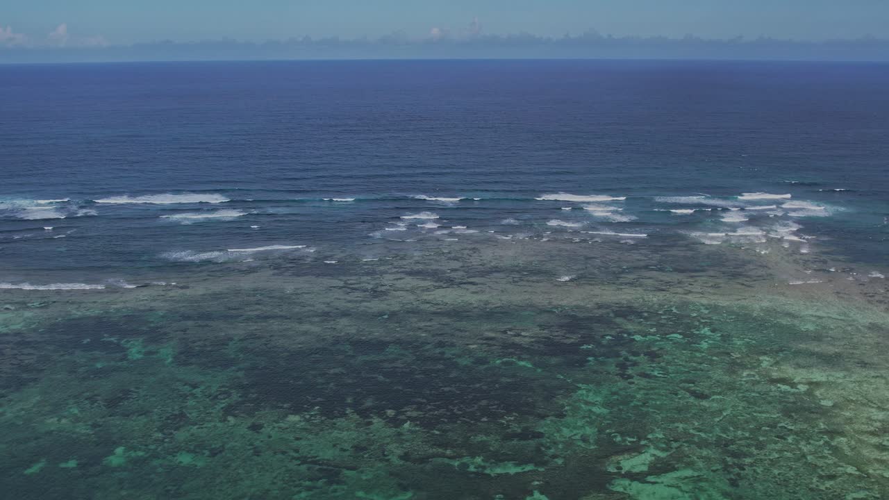 Aerial footage of a shallower blue lagoon of corals in the ocean