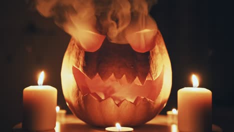 halloween pumpkin with burning candles and thick smoke around it, glows among the darkness on a dark background. traditional halloween jack symbol with bright lights. emotions