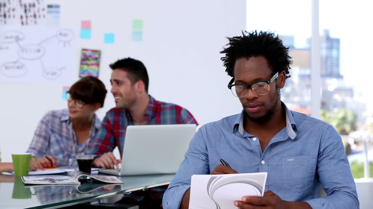 Handsome designer drawing on a notepad