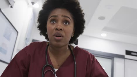 African-american-female-doctor-running-in-hospital-corridor,-slow-motion