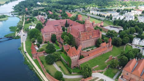 gothic castle complex in the riverside town of malbork in poland. aerial drone shot