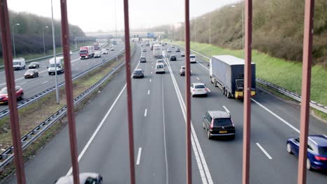 utrecht netherlands highway light traffic looking trough fence on overpass