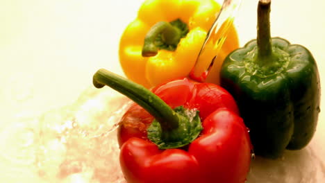 water pouring on selection of peppers