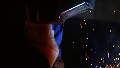 welding sparks hits worker's mask