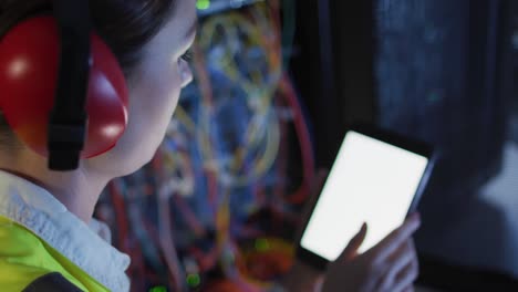 Caucasian-female-it-technician-using-tablet-with-blank-screen-checking-computer-server