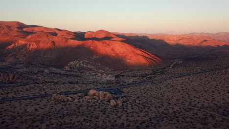 rising aerial shot of live oak picnic area in joshua tree national park at sunset, california