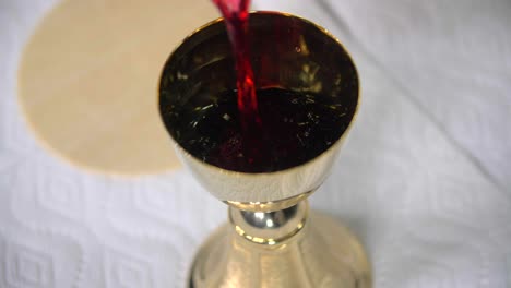 Pouring-Wine-Into-Goblet-Eucharist-Cavanah-Bread-Communion-Pope-Peter-Christian-Catholic-Episcopal-Lutheran-Southern-Baptist-Church-Denomination-Body-Of-Christ-Jesus-Crucifixion-Savior-Righteous-Mass