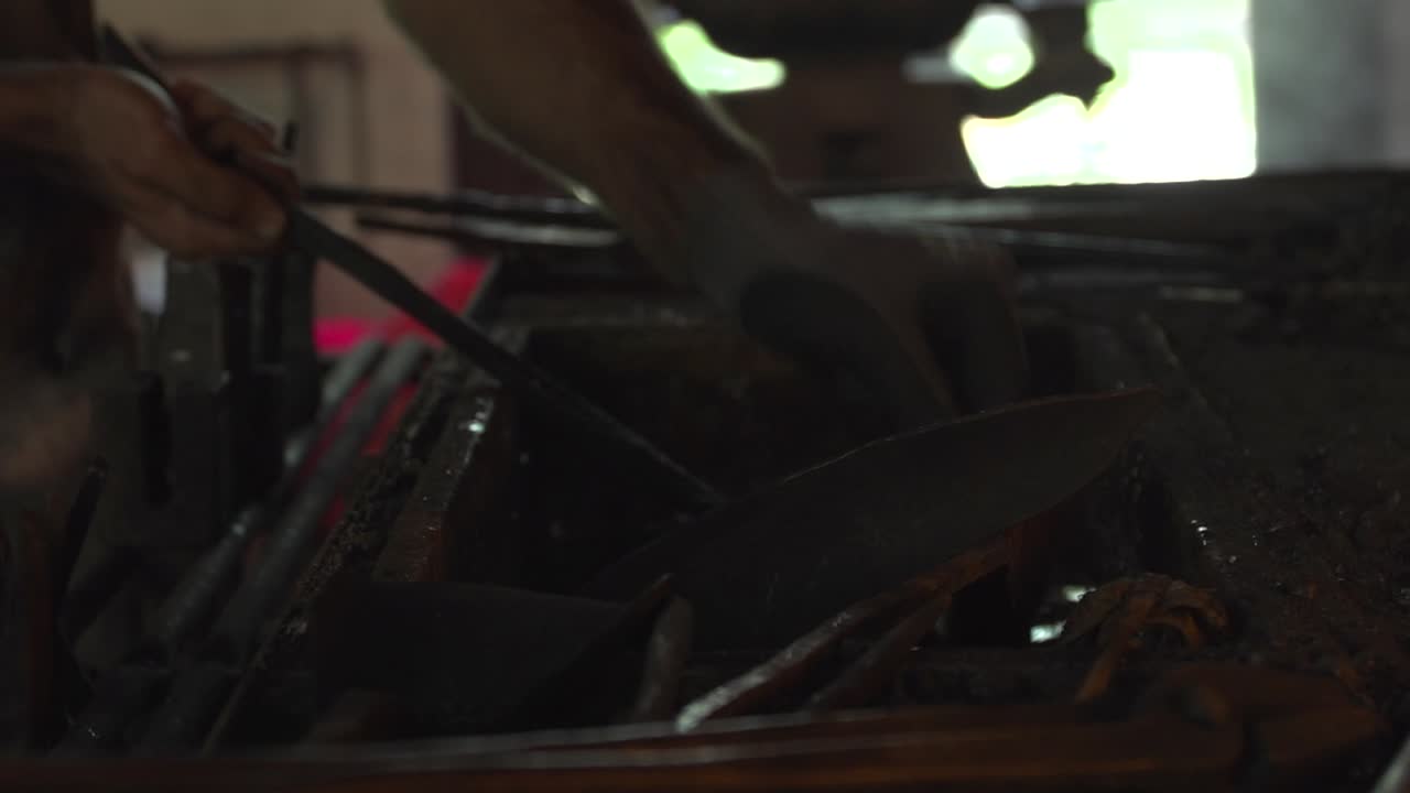 Smith fire used to heat up metal to high temperatures with coals inside a craftsman workspace