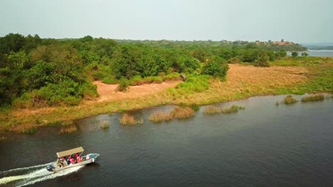 Murchison-Falls-National-Park-With-Grazing-Animals-And-Tourist-Boat-In-Uganda,-East-Africa