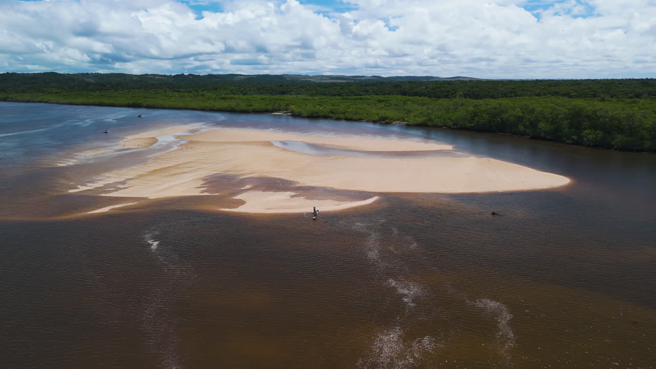 Aerial View of a River with a Sandbar and People in a Boat