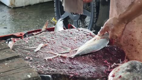 fish being cut at a market