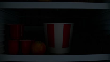 inside a fridge with popcorn and yogurt