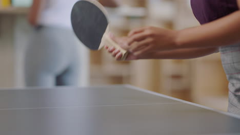 young business woman hands playing ping pong enjoying competitive game having fun on lunch break in office close up