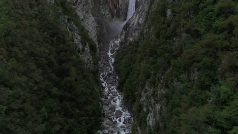 aerial drone shot revealing a big waterfall in slovenia, flying upwards, 4k uhd