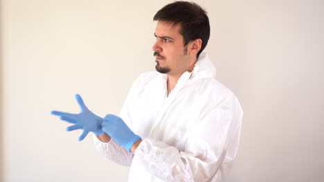 Doctor-in-PPE-suit-putting-on-glove-decided,-ready-to-work