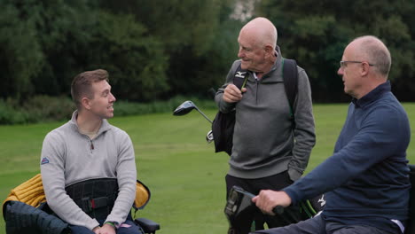 Three men on a golf course having a conversation