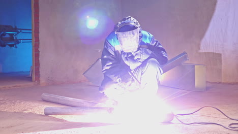 welder working on metal pipes