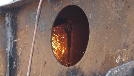 Yellow-Sparks-Flying-Inside-Hull-At-Breakers-Yard