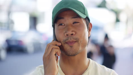 a young man talking on a cellphone while out