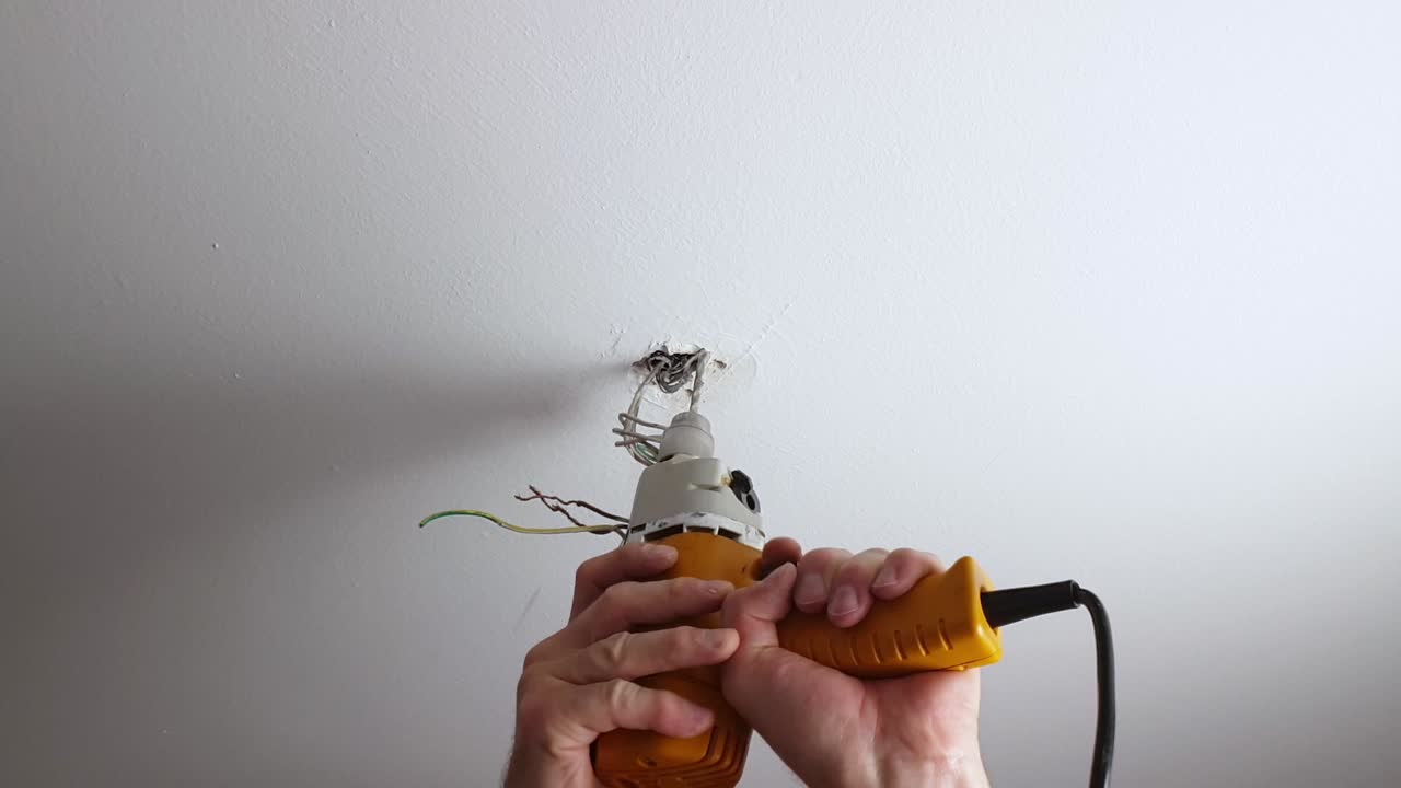 Drilling a hole into a ceiling for a ceiling light