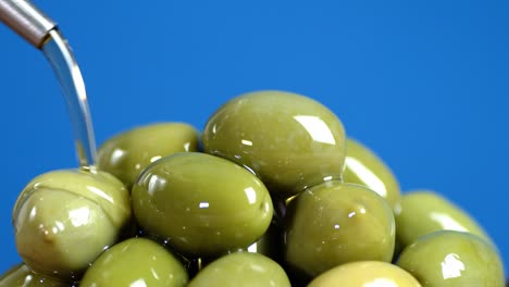 olive oil is poured on the olives.