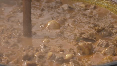 Boar-stew-boiling-and-smoking-in-a-rotating-cauldron---180-fps-slow-motion